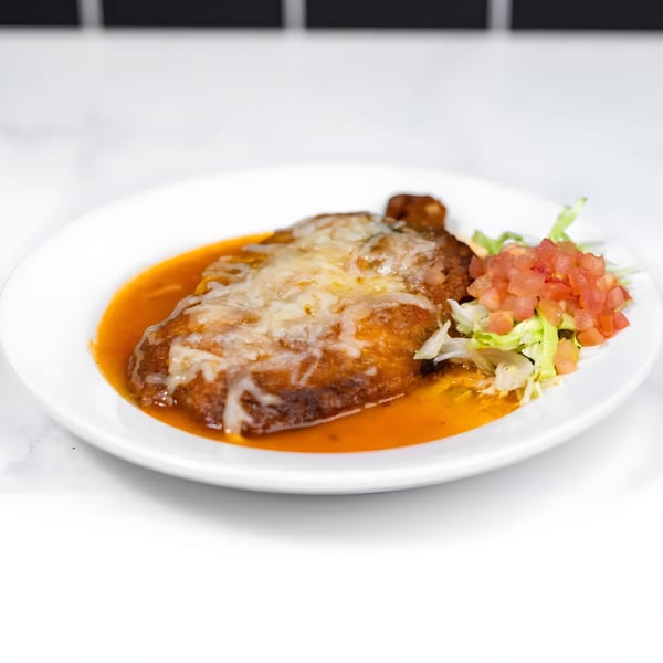 Margarita's Cocina y Cantina's chile relleno, covered in melted cheese and red sauce, with a side of pico de gallo.